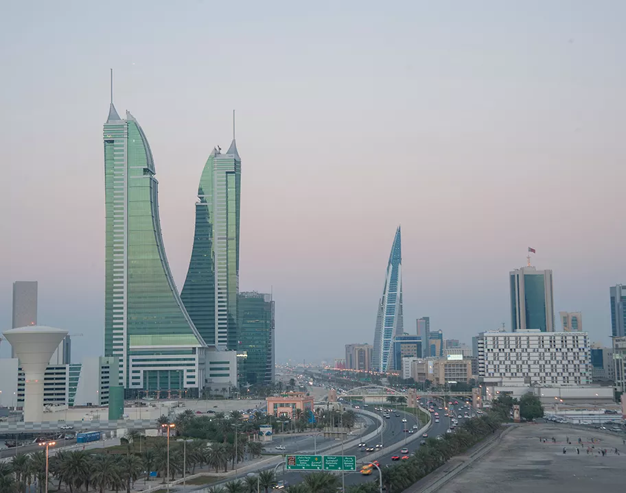 A panoramic view of Bahrain Financial Harbour at dusk, with its distinctive twin towers standing prominently along the Manama skyline—home to Servcorp serviced offices